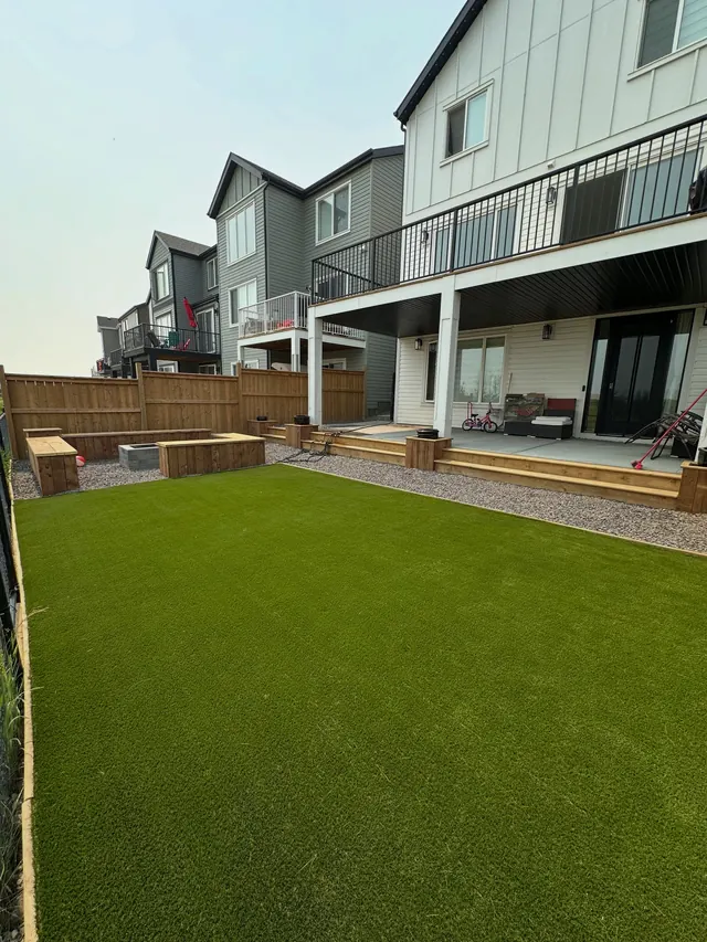 Level artificial turf lawn behind a two-storey home
