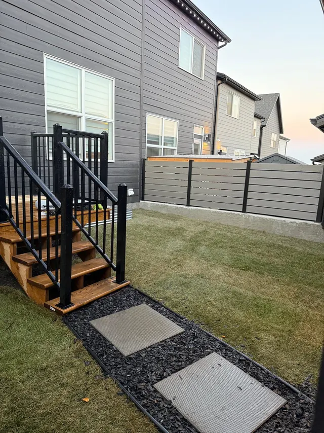 Deck stairs with slab stepping stones and a composite fence