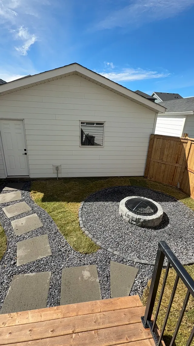 Fire pit and slab pathway across a rear yard