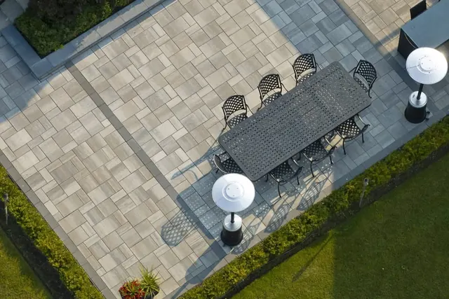 Aerial view of a paver patio and dining area
