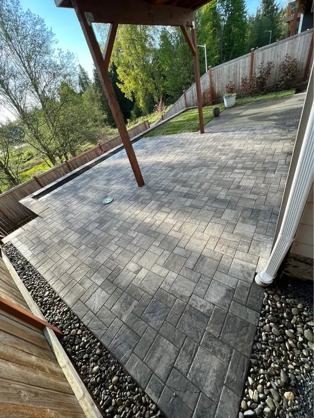 Paver patio beneath a timber pergola