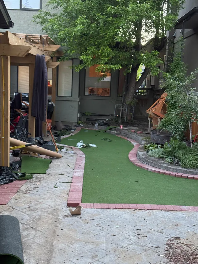 Full yard build in progress, turf and paver edging laid
