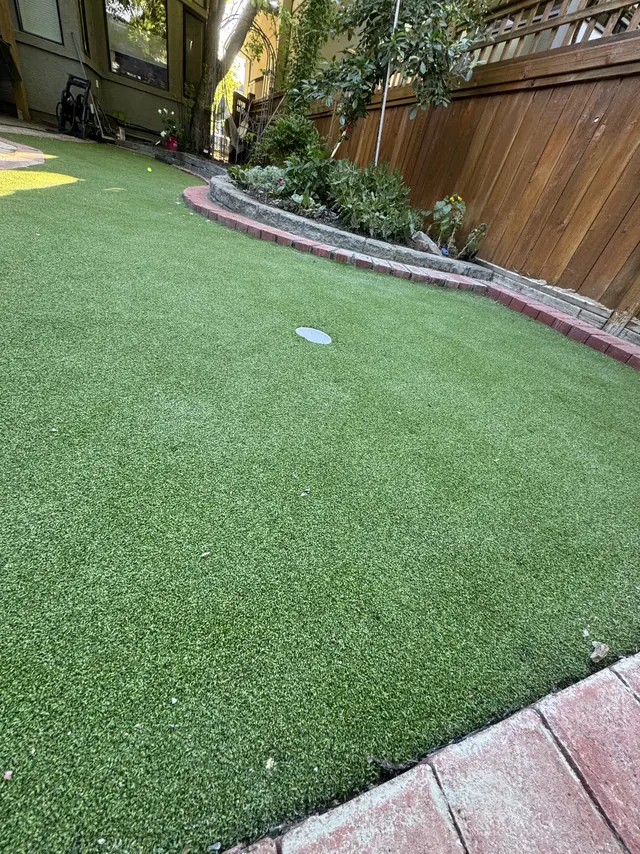 Putting green with cup and paver border