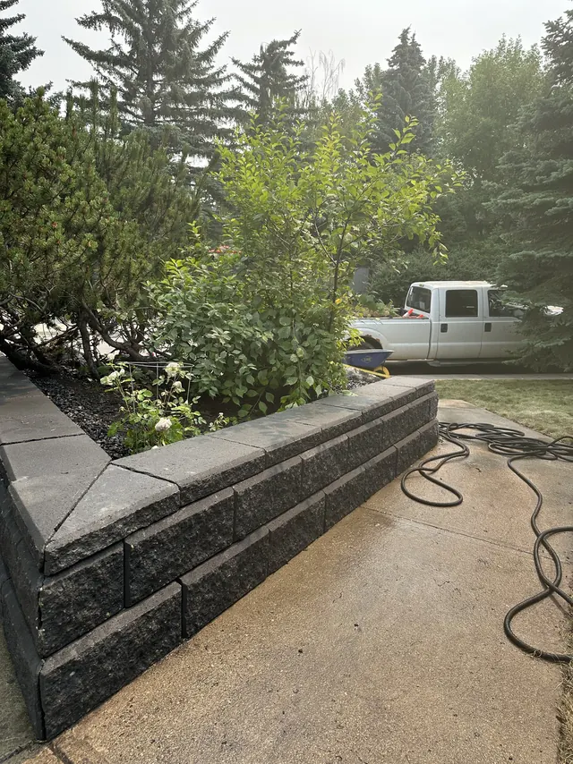 Block retaining wall running alongside a walkway