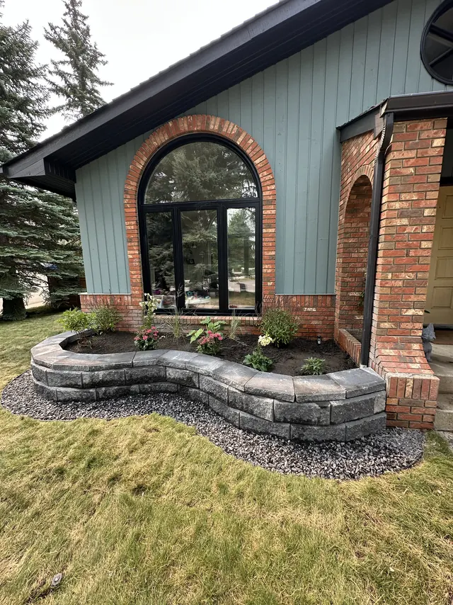 Curved block planter wall by the front entry