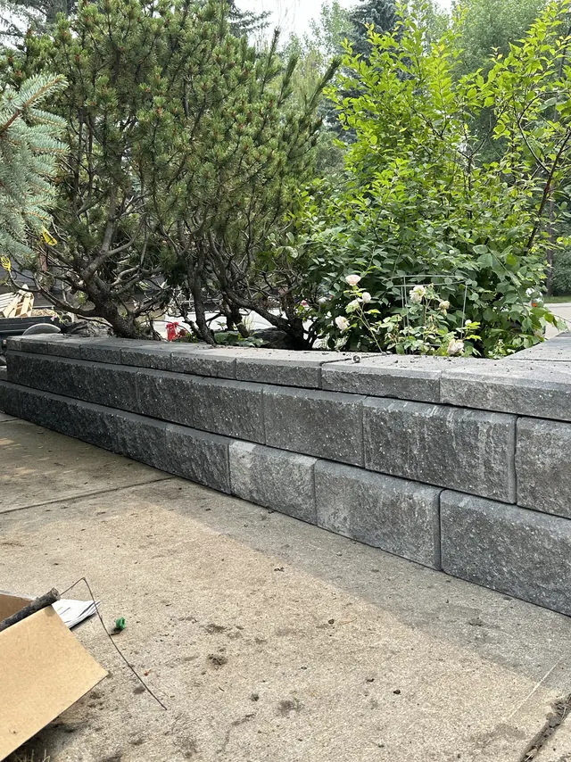 Block retaining wall along a sidewalk