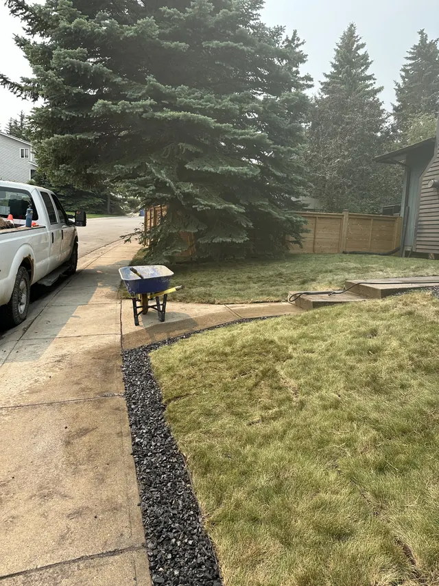 Rock-edged bed being formed in a front yard